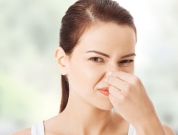 Woman reacting to bad odor